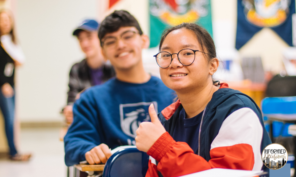 Female student with their thumbs up